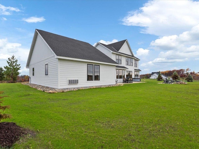 rear view of house with a lawn and a patio