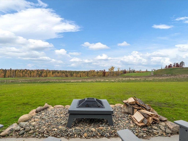 view of yard featuring a fire pit and a rural view