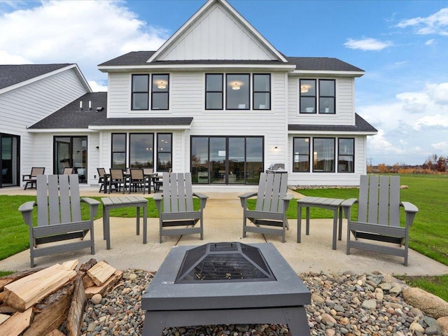 rear view of property with a patio area and an outdoor fire pit