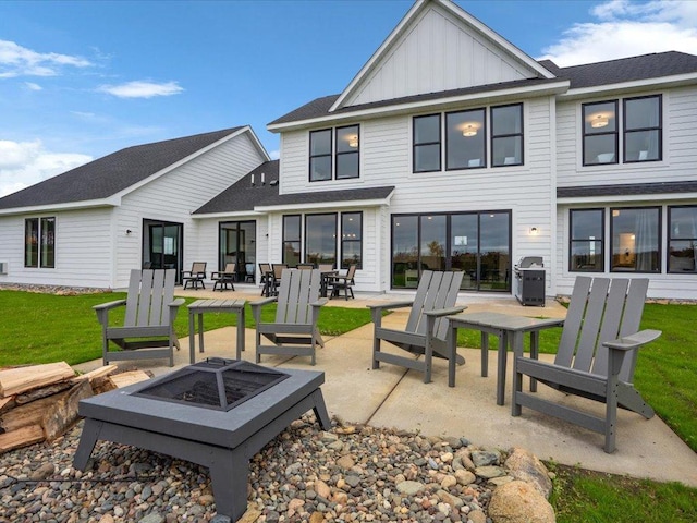 back of house with a patio area and a fire pit