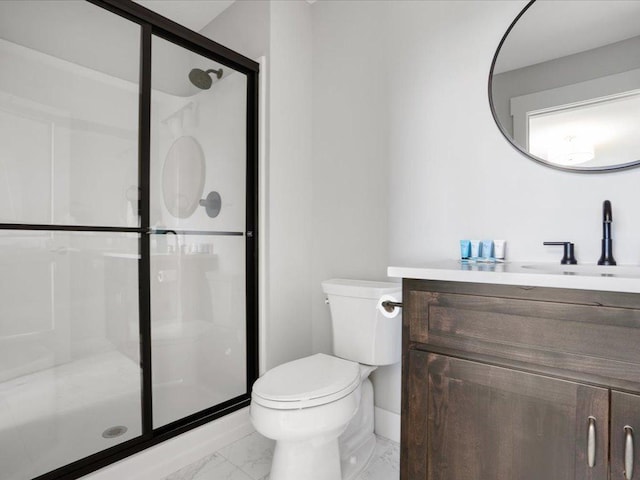 bathroom with vanity, toilet, and a shower with shower door