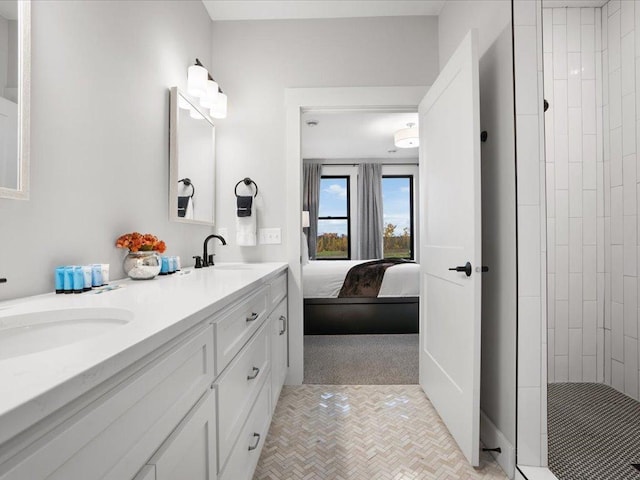 bathroom with tiled shower and vanity