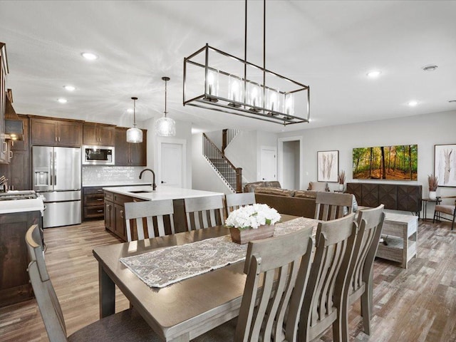 dining space with wood-type flooring and sink