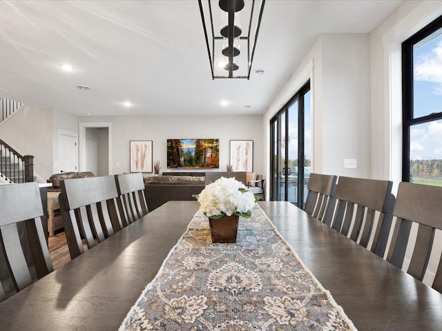 dining space with a healthy amount of sunlight and hardwood / wood-style floors