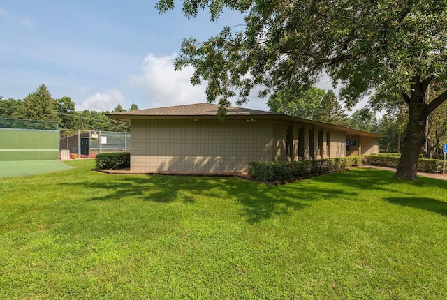 view of side of property with a yard