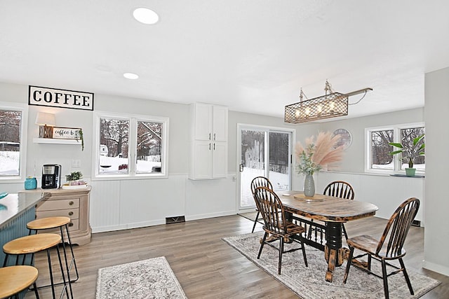 dining space featuring light wood-type flooring and recessed lighting