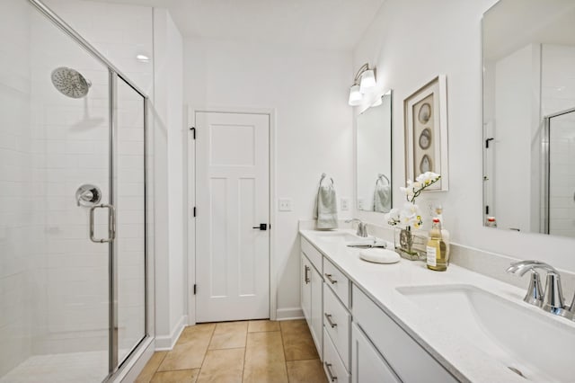 bathroom featuring tile patterned floors, an enclosed shower, and vanity