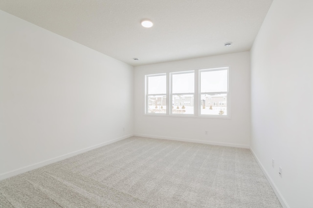 empty room with light colored carpet