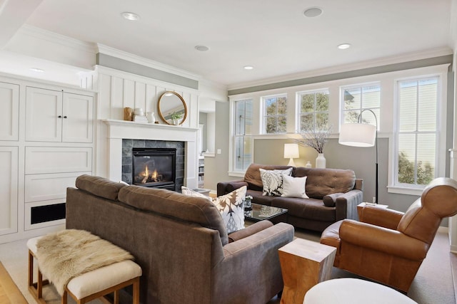 living area with recessed lighting, a fireplace, and ornamental molding