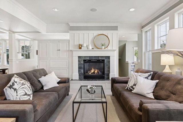 living area with a tiled fireplace, crown molding, and recessed lighting