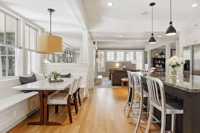 dining room with recessed lighting, light wood-type flooring, and breakfast area