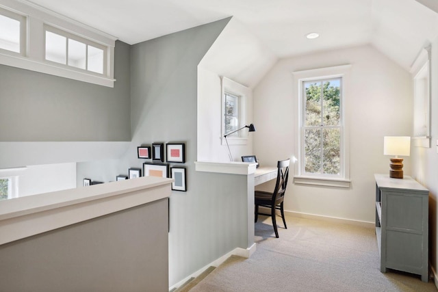 office featuring baseboards, light colored carpet, and vaulted ceiling