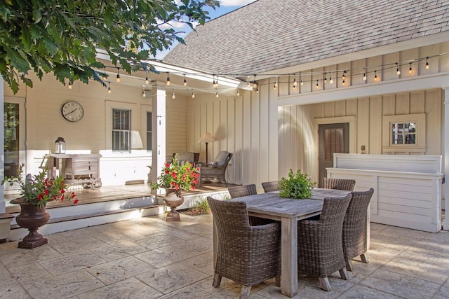 view of patio with outdoor dining space and a wooden deck