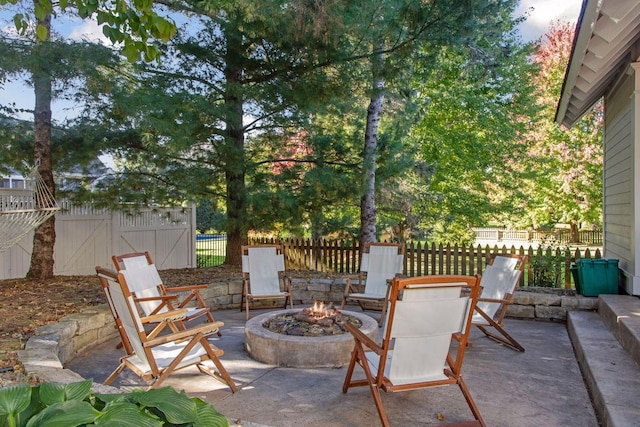 view of patio / terrace with fence and an outdoor fire pit