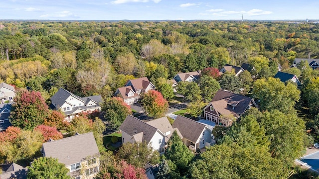 birds eye view of property featuring a residential view and a forest view