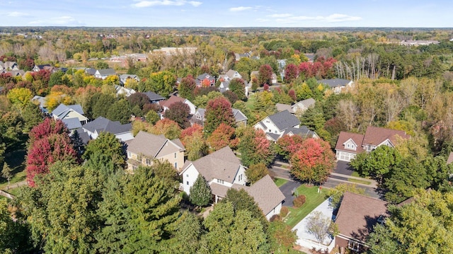 drone / aerial view featuring a residential view and a view of trees