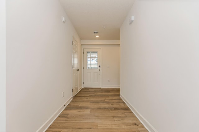 corridor with light hardwood / wood-style flooring