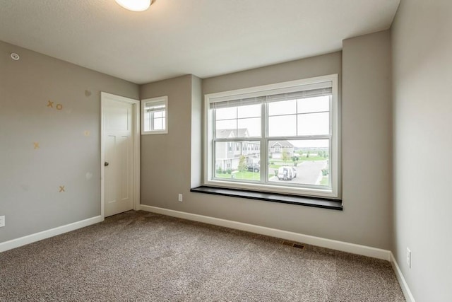 unfurnished room with carpet floors