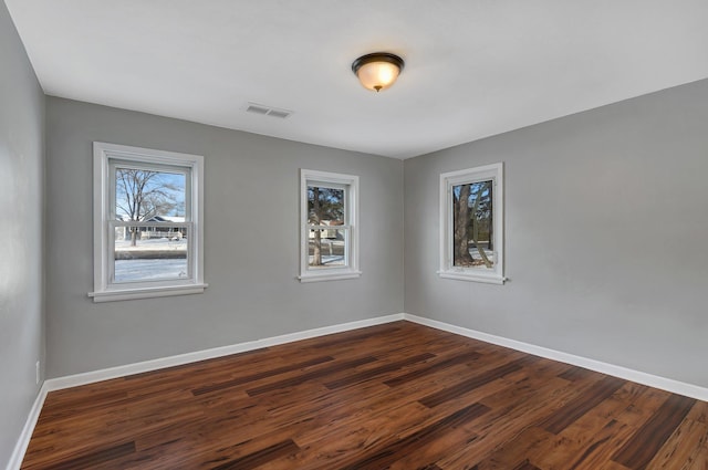 unfurnished room featuring dark hardwood / wood-style floors