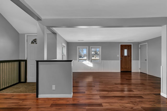 foyer entrance featuring a wainscoted wall, visible vents, and wood finished floors