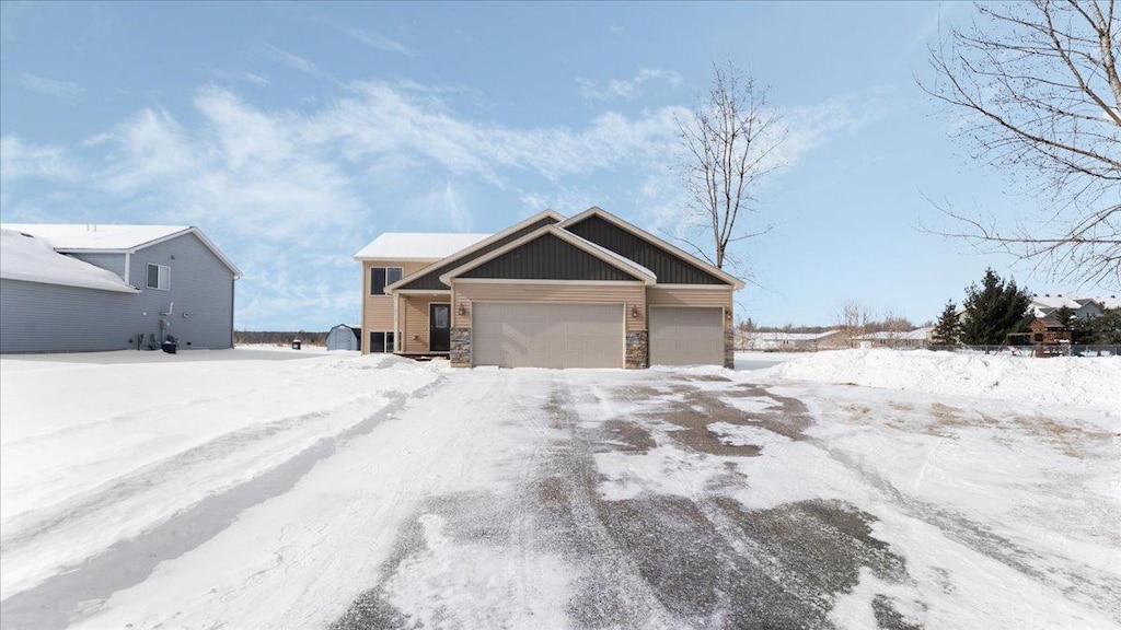 view of front of home featuring stone siding and an attached garage