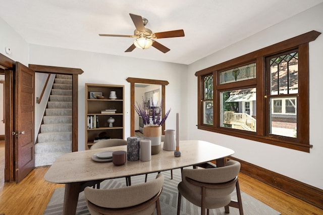 dining room with light hardwood / wood-style flooring and ceiling fan