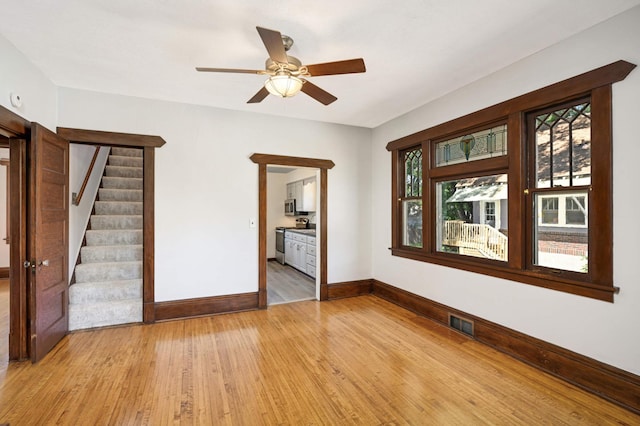 unfurnished room featuring ceiling fan and light hardwood / wood-style floors