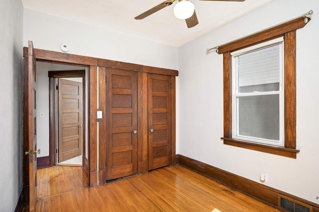 unfurnished bedroom with hardwood / wood-style floors and ceiling fan