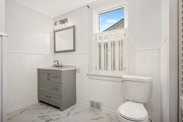 bathroom featuring vanity and toilet