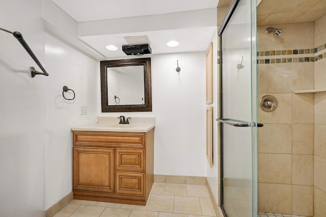 bathroom with an enclosed shower, vanity, and tile patterned floors