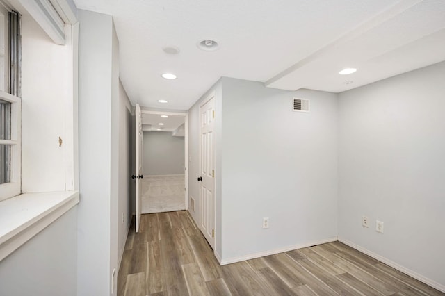 corridor with light wood-type flooring