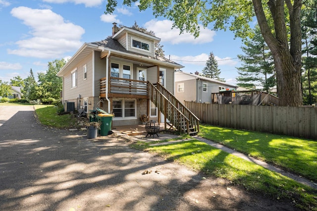 back of house featuring central AC, a yard, and a patio area