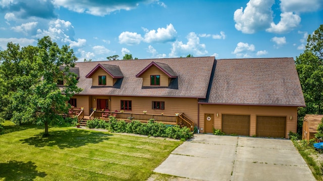 view of front of home featuring a wooden deck, a garage, and a front lawn