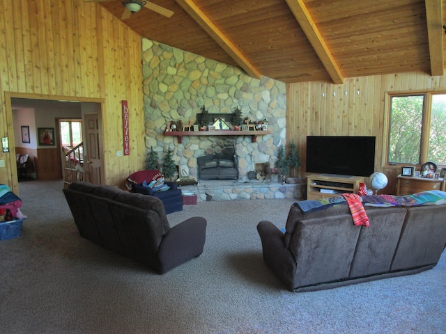 living room with beamed ceiling, wood ceiling, wooden walls, and carpet floors