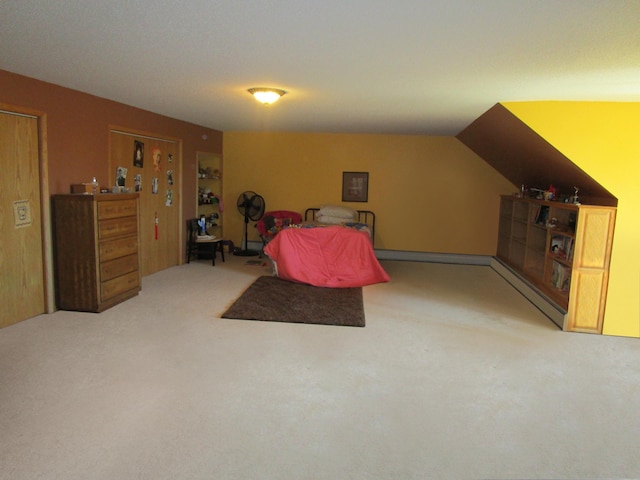 carpeted bedroom with lofted ceiling and baseboard heating