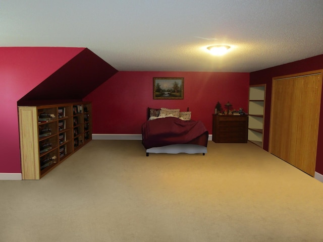 carpeted bedroom with lofted ceiling and a textured ceiling