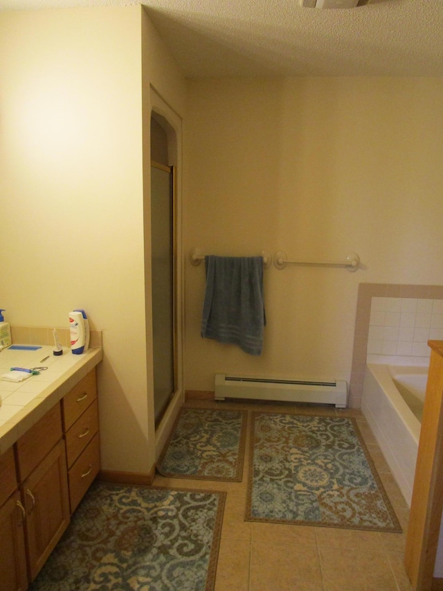 bathroom with baseboard heating, tile patterned flooring, vanity, a textured ceiling, and separate shower and tub