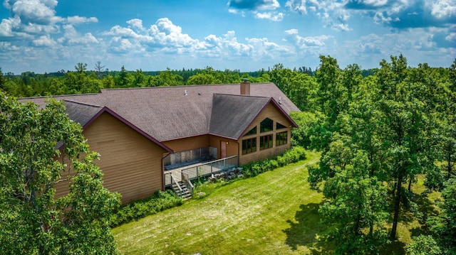 rear view of property with a yard and a deck