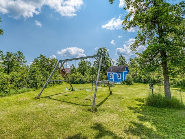 view of jungle gym with a lawn and a storage unit