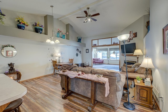 living room with hardwood / wood-style flooring, ceiling fan, high vaulted ceiling, and beamed ceiling