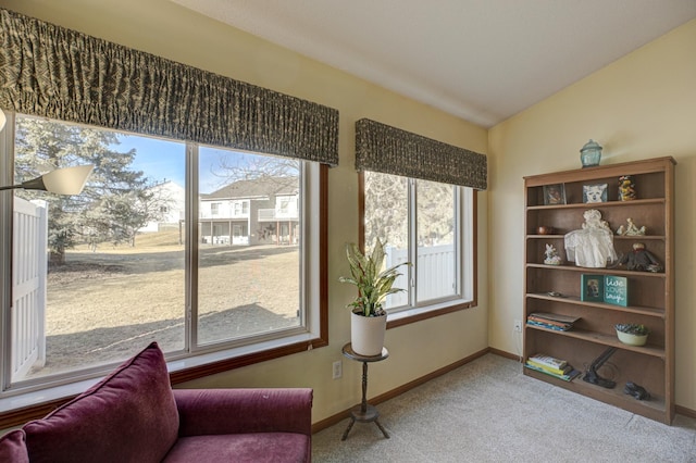 living area featuring vaulted ceiling and carpet