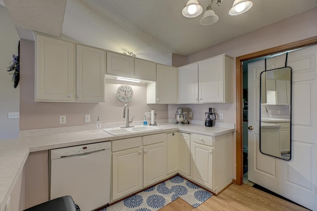 kitchen with sink, a textured ceiling, light wood-type flooring, dishwasher, and white cabinets