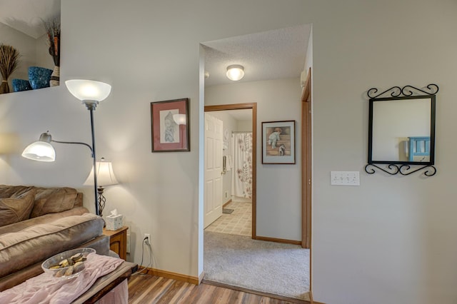 interior space featuring a textured ceiling and light hardwood / wood-style flooring