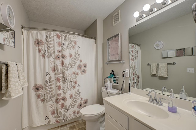 bathroom with vanity, curtained shower, a textured ceiling, and toilet