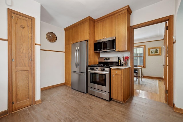 kitchen with stainless steel appliances and light hardwood / wood-style floors