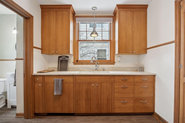 kitchen featuring hanging light fixtures, sink, and dark hardwood / wood-style flooring