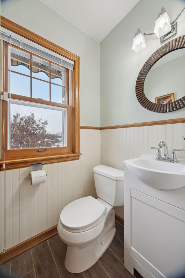 bathroom featuring hardwood / wood-style flooring, vanity, and toilet