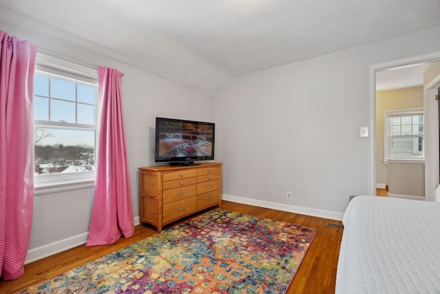 bedroom featuring hardwood / wood-style flooring and vaulted ceiling