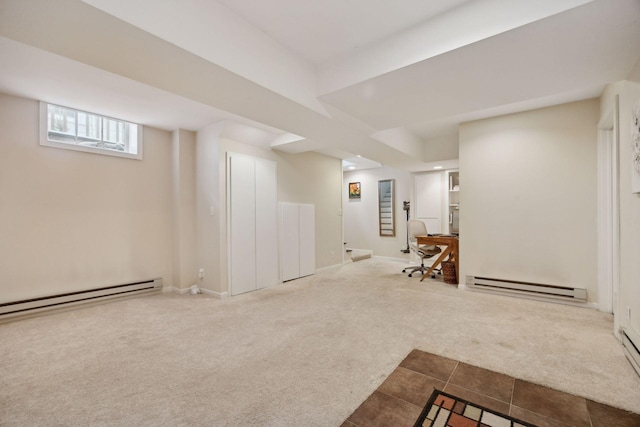 basement featuring baseboard heating and carpet flooring