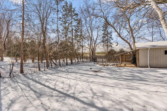 yard covered in snow with fence